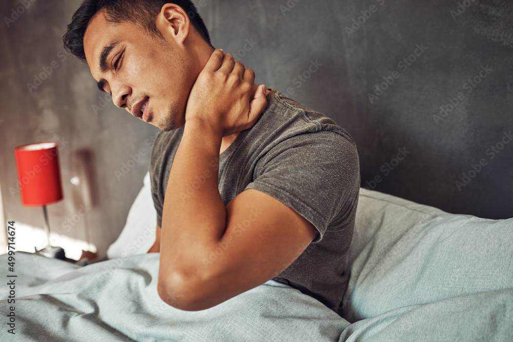 Sticker Anybody got the number of a good sleep clinic. Shot of a young man experiencing neck pain after waking up in bed at home.