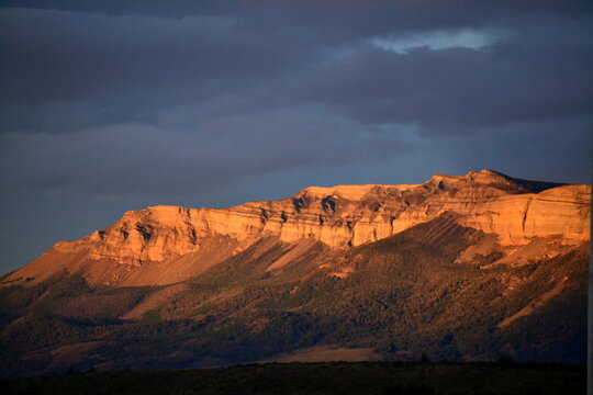 Mountain called Dorotea in Patagonia Chili illuminated with sunset light near Puerto Natales with dark rainy sky. High quality photo