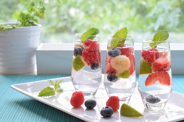 Welcome Drink on the table, soda with banana,strawberries, raspberries, blueberries, lime and mint 