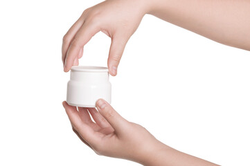 Hands holding cosmetic cream container isolated on white background.