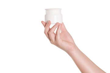 Hand holding cosmetic can of cream on white background.