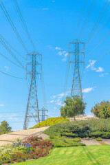 Transmission towers with power line cables on a field at Ladera Ranch in California