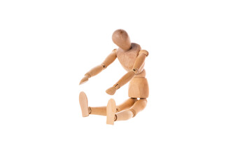 a wooden man sits and stretches to his feet isolated on a white background. Stretch concept