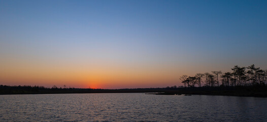 sunrise at coast of the lake. Nature landscape in the morning.