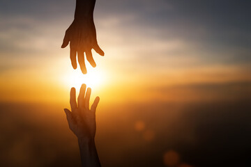 Silhouette of reaching, giving a helping hand, hope and support each other over blur sunset sky...
