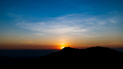 Beautiful sunrise landscape on the mountain of thailand. Golden and blue sky sunrise in the morning.