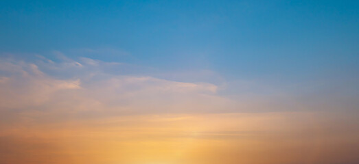 Naklejka na ściany i meble Bright orange sunset sky background with gentle colorful clouds, soft focus