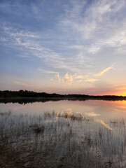 Sunrise cloudscape reflected in calm water of Nine Mile Pond in Everglades National Park, Florida in April.