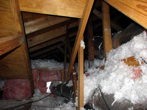 Insulation And Venting Pipes And Tubes In Attic Crawl Space With Wooden Roof Rafter Supports