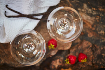 And now for something sweet. Shot of a two empty glasses on a table with strawberries next to them.