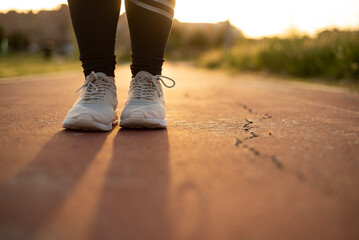 Young female running outside at sunset 