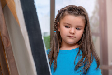 Child looks at an easel
