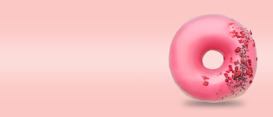 Tasty donut on pink background with space for text