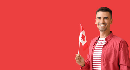 Young man holding Canadian flag on red background with space for text