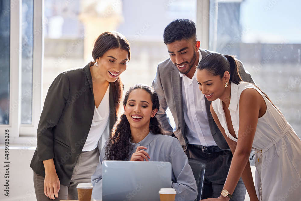 Poster ambition is what allows them to succeed. shot of a group of businesspeople working together on a lap