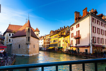 Fototapeta na wymiar Scenic cityscape of old town of Annecy, southeastern France.Medieval city of Annecy with Thiou canal at sunny winter day, Haute Savoie department in Auvergne Rhone Alpes region, France