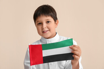 Cute little boy with national flag of UAE on light background