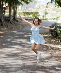 Young latina woman enjoying sunny afternoon in Costa Rica. Empowered woman, professional, woman in her 20's. LGTBI woman. young latina woman shopping. out of focus background. copy space for advertisi