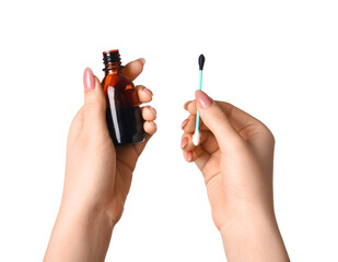 Female hands with cotton swab and bottle of iodine on white background