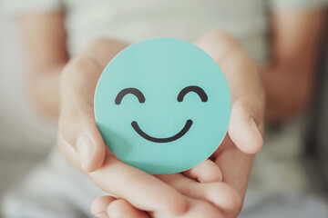 Hands holding green happy smile face paper cut, good feedback rating,think positive, customer...