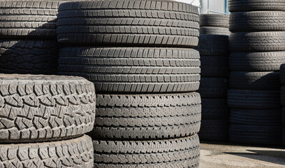 Pile of new tires. Many car and truck tyres in a pile - Powered by Adobe