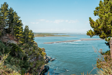 Horizontal shot, from a cliff, of the south side of the mouth of the bio bio river connecting with...