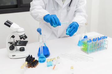 Fototapeta premium Medical Science Laboratory: Portrait of a beautiful scientist looking under a microscope analyzing a test sample. Ambitious young biotechnology specialist work with advanced equipment