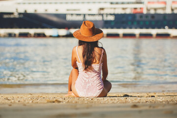 Latin woman sitting on the beach, enjoying the sunset. Woman reading book. Woman on the beach of Huatulco Oaxaca. relaxed young woman. Background cruise. Happy woman on vacation in Mexico. Resting in 