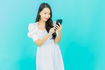 Portrait beautiful young asian woman smile with smart mobile phone