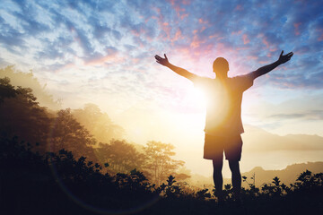 Fototapeta na wymiar Copy space of man raise hand up on sunset sky