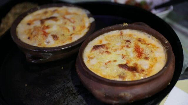 Gourmet seafood. Closeup view of a King Crab hot bubbling cake in a bowl, in the restaurant kitchen.