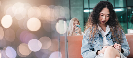 Passenger traveler woman in airport gate play smartphone for waiting air vacation travel, hipster female sitting and using mobile phone in terminal hall area while waiting for her traveling flight