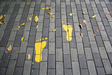 yellow footprints symbol on the floor