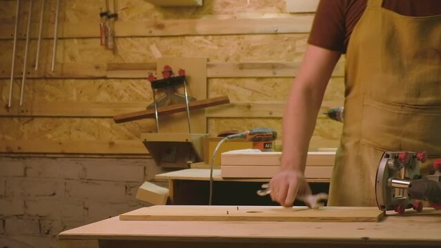 A mature man prepares the boards to work with a circular saw