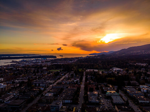Aerial view of North and West Vancouver at sunset with Vancouver and English Bay in teh distance