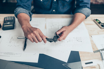 Architecture hands hold vernier caliper working and checking joint pipe scale with bathroom...
