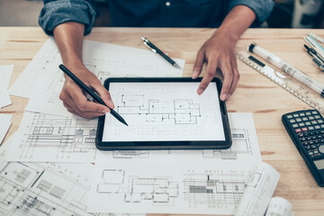 Architect engineer use tablet to read drawing design. House planning design and construction...