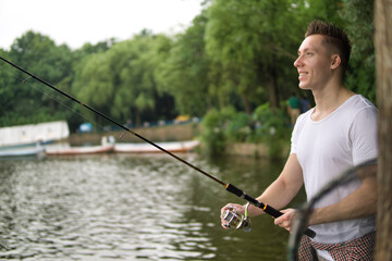 Young man fishing on a lake.
