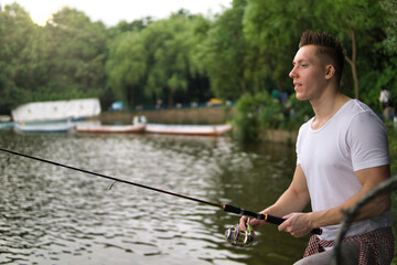 Young man fishing on a lake.