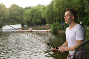 Young man fishing on a lake.