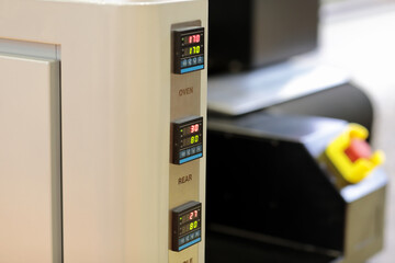 digital temperature controllers on a control panel