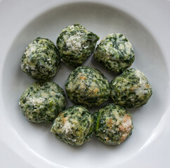 Italian Gnudi are a typical first course dish of Tuscan cuisine. Gnudi are large gnocchi made with ricotta, spinach, Parmigiano Reggiano cheese, but without pasta.
