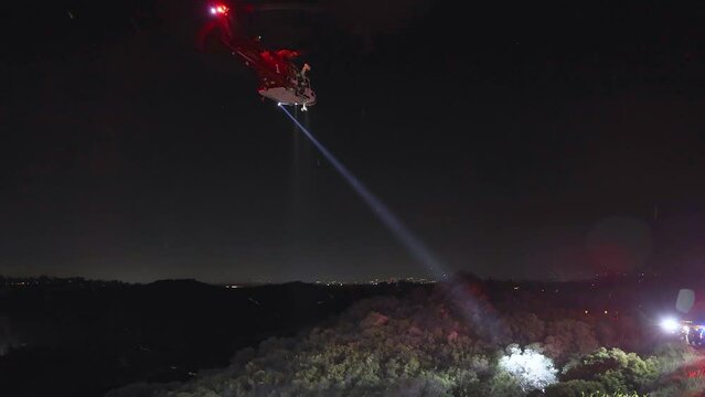 Helicopter on a search and rescue mission, night in highlands of California, USA