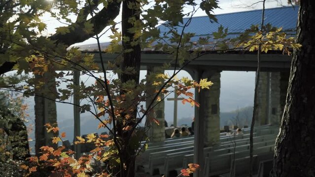 People enjoying the view of pretty place Fred W Symmes Chapel in South Carolina on a sunny autumn day. Slowly Panning shot