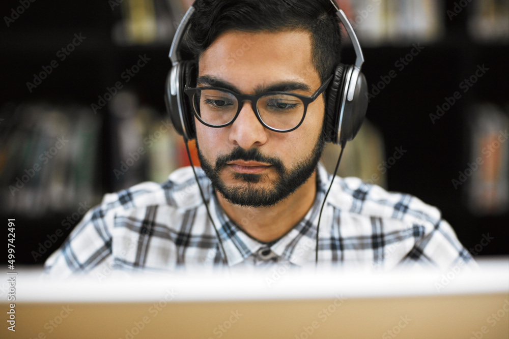 Fototapete its going to be a long day for me. closeup shot of a focused young man sitting and working on a comp