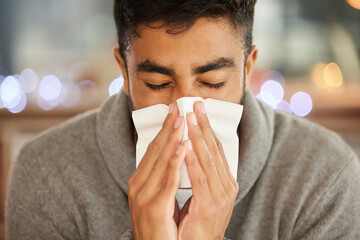 What am I going to do about this flu. Shot of a young man blowing his nose.