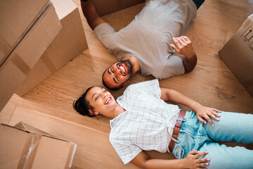 We can finally create the home weve always wanted to. Shot of a happy couple lying on the floor...