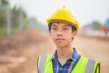 Young engineer man at construction site, Foreman worker inspecting at road construction site
