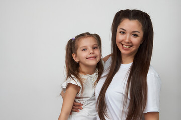 Happy woman and child girl 5-6 years old having fun