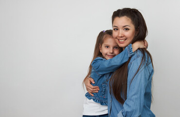 Happy woman and child girl 5-6 years old having fun